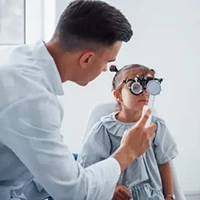 Child undergoing vision check with optometrist in a modern eye clinic in Calma, Algeria